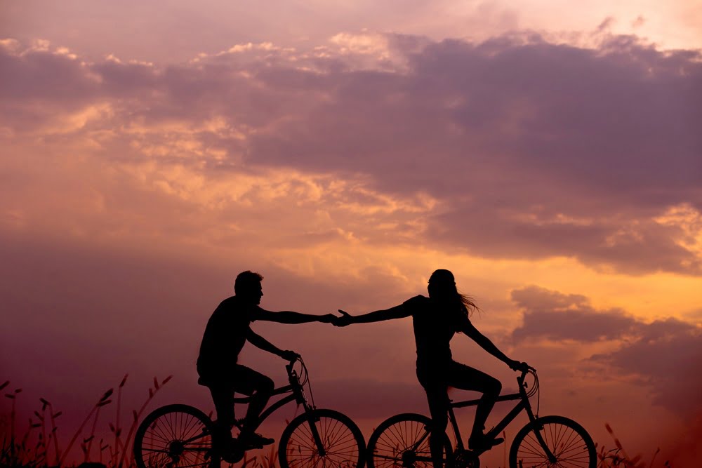 Couple on bicycles at sunset