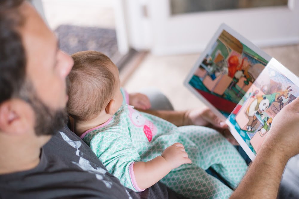 Father reading a story to baby
