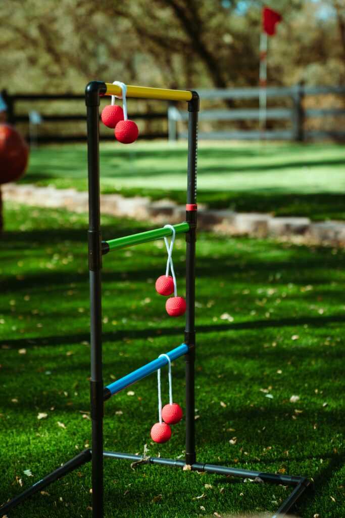 A game of ladder ball at a summer lawn party.